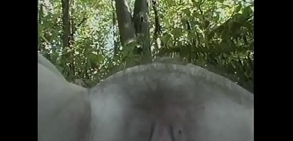  Naughty bbw with big tits gives a guy a blowjob in the forest, and her friend masturbates on the grass